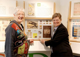 Kathleen Morris, left, and Cheryl Ganz, pointing to Washington Island resident James E. Anderson’s hunting license with duck stamp.